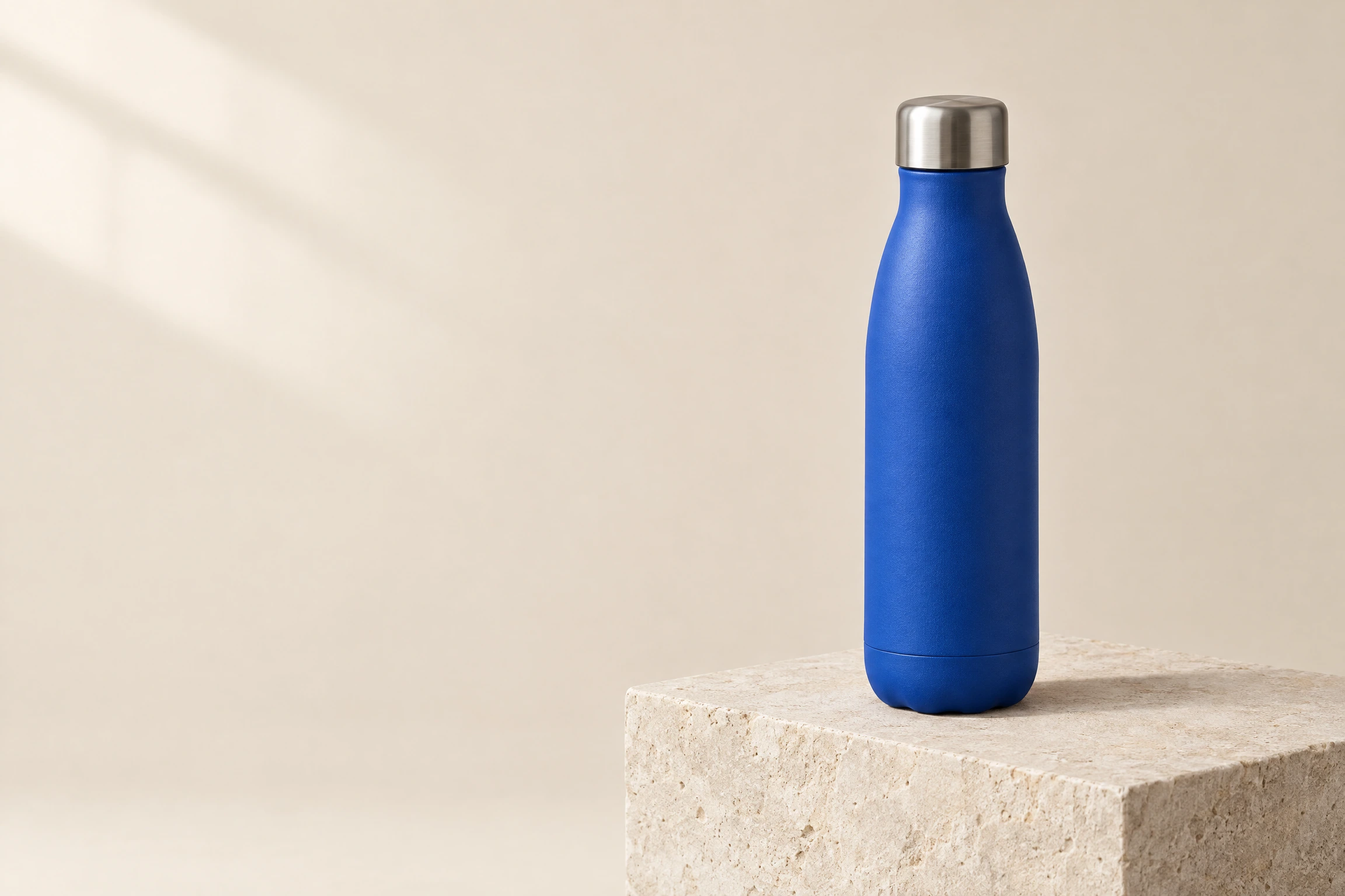 GPT Image 2.5 Flare: a cobalt-blue bottle on limestone, 2304 × 1536 pixels.